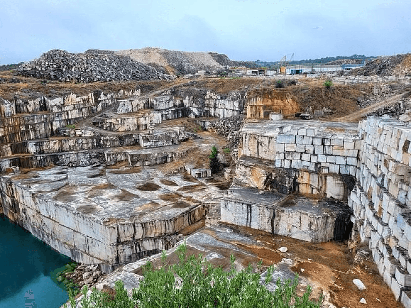 Terraced open-pit quarry with cut stone benches