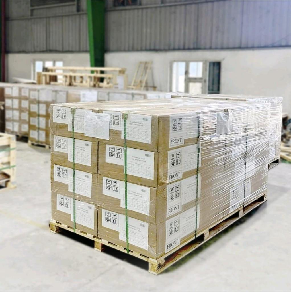 Shrink-wrapped pallet of labeled prefab vanity tops ready for container loading