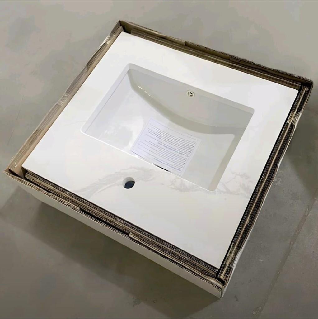 Carrara quartz vanity top with integrated sink packed in an open shipping carton